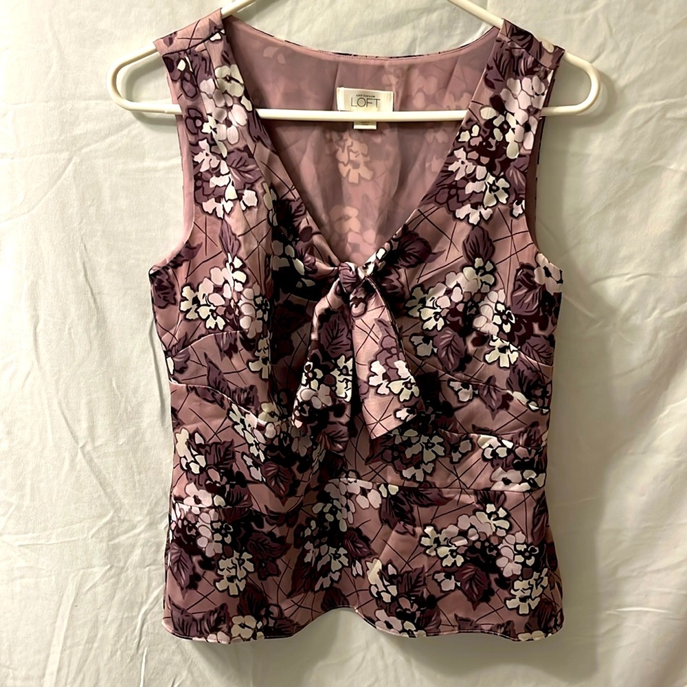 This is a purple flowered Ann Taylor LOFT blouse that is a size medium.